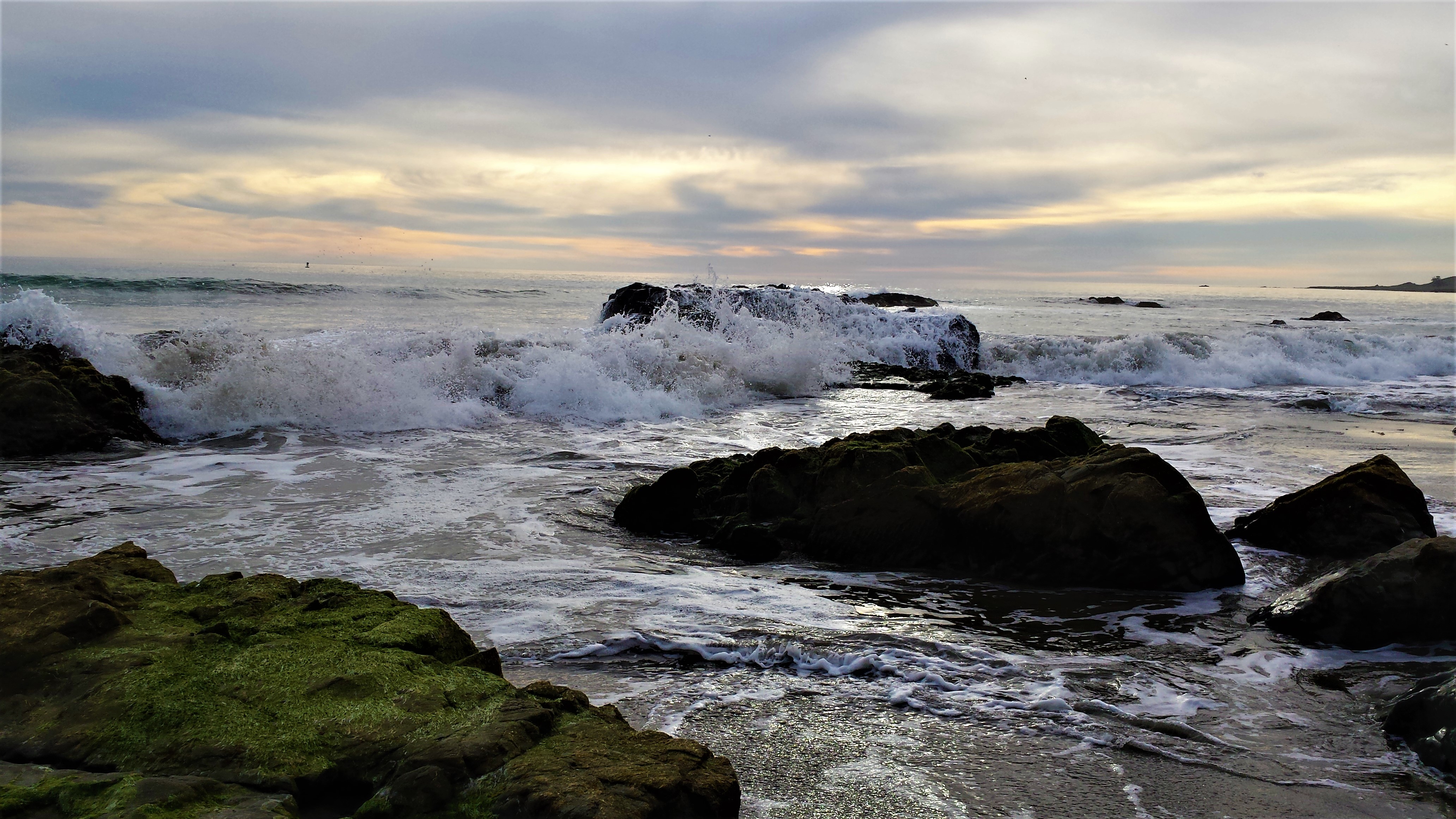 Waves over ocean rocks
